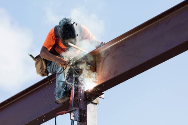welder working on metal structure welder working on metal structure